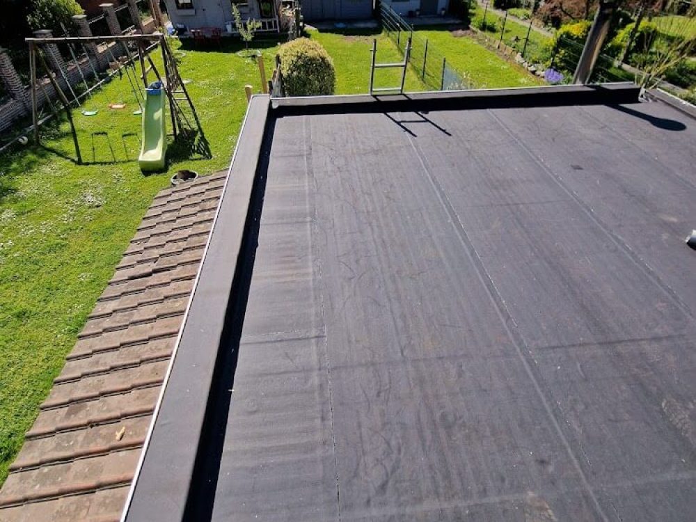 Toit plat en bitume terminé, vu depuis un jardin